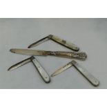Two Edwardian folding fruit knives having HM silver blades and mother of pearl handles, a similar