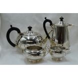 A four piece silver tea set of plain compressed circular and baluster form having banded waist,