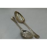 A pair of George II silver table spoons of hanovarian form having fan pattern to reverse of bowls