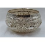 A Burmese silver bowl having elephant and oxen scenic repousse decoration and presentation