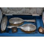 A cased part set of silver dressing table brushes having having engine turned moon shine decoration,