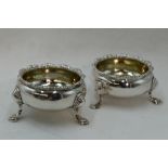 A pair of Georgian silver open salts having trefoil hoof feet and shaped rims, London 1752, makers