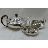 A silver three piece silver breakfast set of plain compressed circular form having wicker handle and