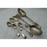 Five Victorian silver teaspoons of fiddle back form bearing monograms to terminals, a Georgian