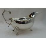 An Irish silver sauce boat having indented rim, loop handle & trefoil hoof feet, Dublin 1971,