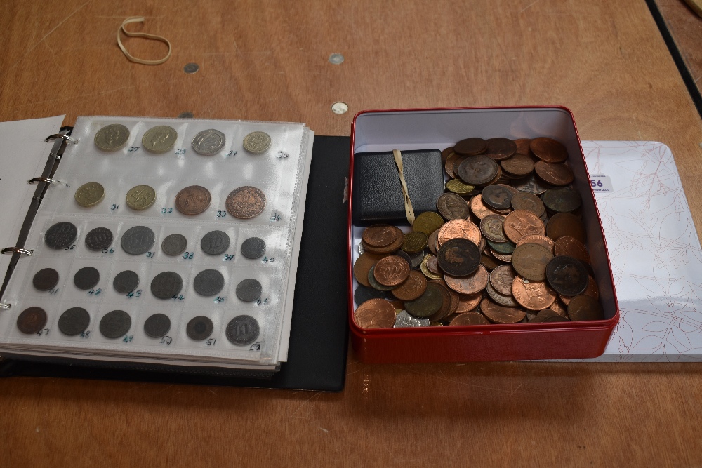 An album and tin of GB and World Coins and Banknotes