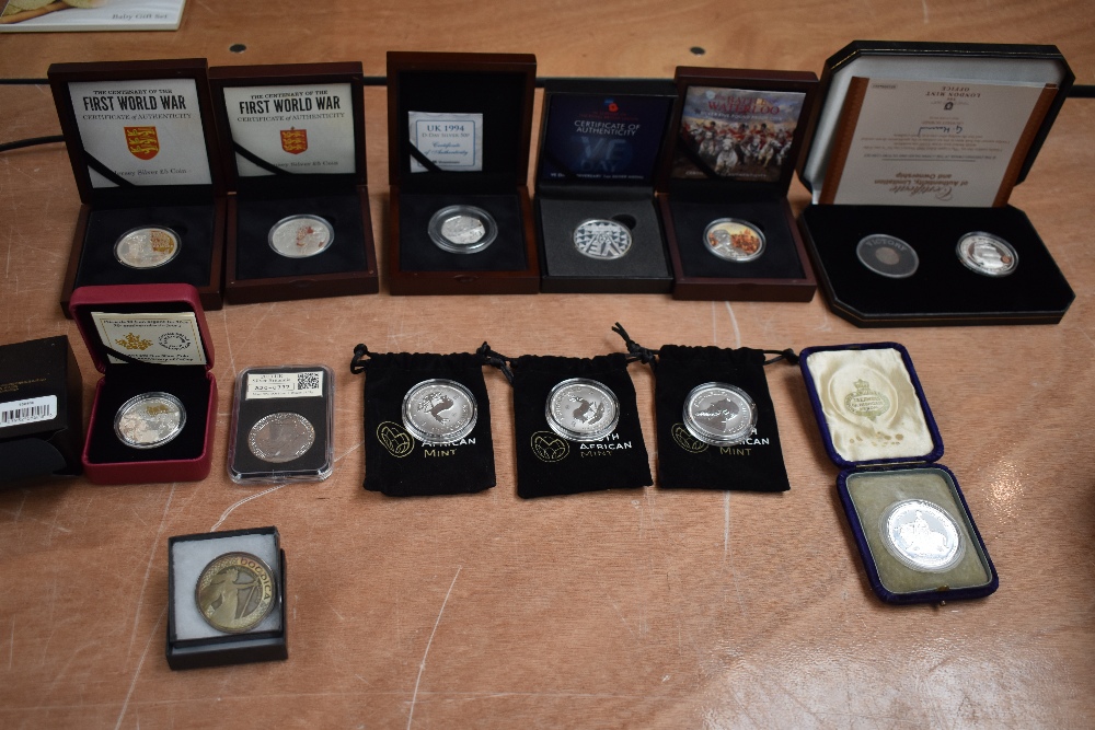 A collection of Silver Coins and Medallions in cases and plastic cases including 5 Pound Coins South