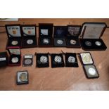 A collection of Silver Coins and Medallions in cases and plastic cases including 5 Pound Coins South