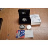 A 2017 2 Pound 1oz Silver Britannia Coin in case, a 50 Pound 2015 Silver Britannia Coin and a 5