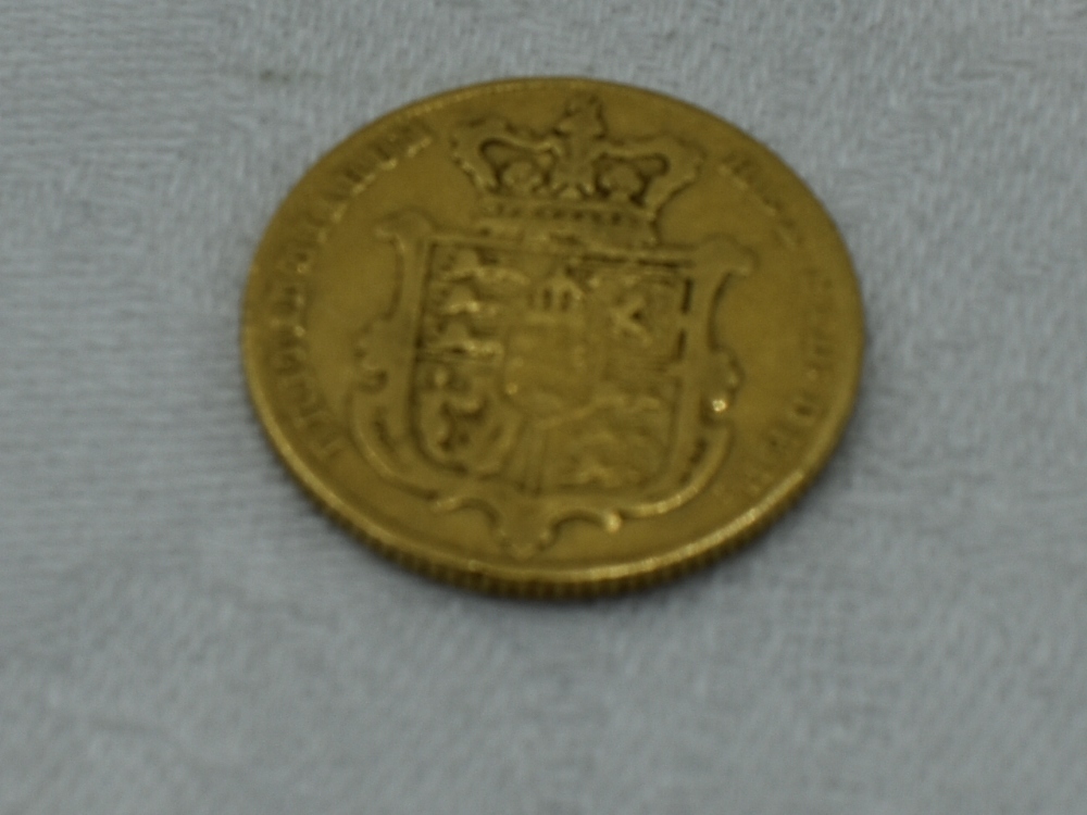 A Gold George IV 1825 Bare Head Sovereign with crown shield on reverse, in plastic case