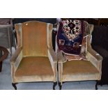 A pair of heavy framed wing back chairs, in the Queen Anne style, later ochre dralon upholstery