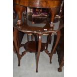 An early 20th Century mahogany occasional table having shaped top and undertier