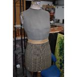 A vintage dressmakers dummy , female form,on wooden tripod base