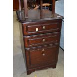 A modern mahogany effect three drawer bedside chest