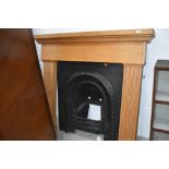 A reproduction cast fire place,and wooden surround