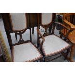 An Edwardian mahogany and inlaid salon armchair and matching chair