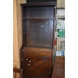 A stained frame Arts and Crafts style narrow bookcase with cupboard under, width approx. 71cm Height