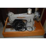 A vintage Seamstress electric sewing machine, in case