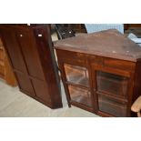 A craftsman made mahogany corner cupboard having display base