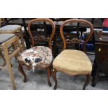 Two Victorian balloon back dining chairs having carved detailing