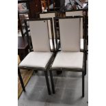 A set of four modern metal (black and gilt) upholstered dining chairs