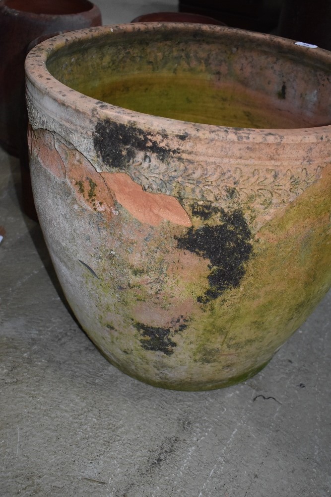 A large terracotta planter, weathered and a few chips, diameter approx. 52cm