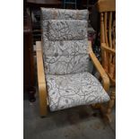 A modern ply Ikea style chair, with cream pattern upholstery, very clean