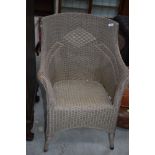 A vintage Lloyd Loom or similar chair, in beige with patterned back