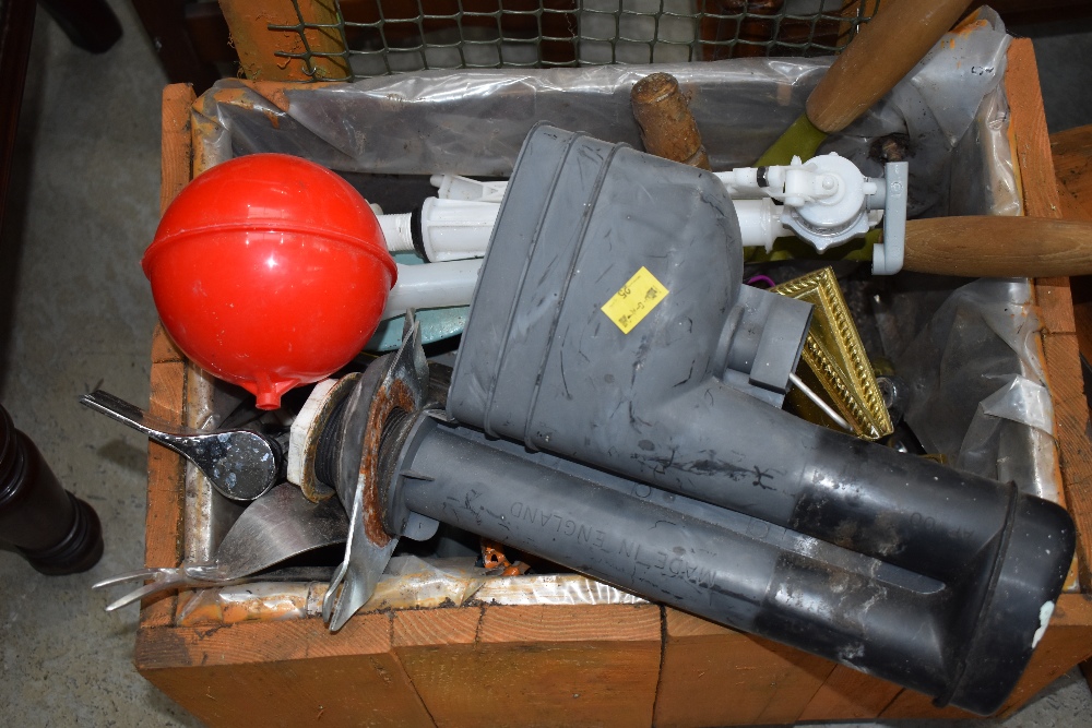 A wooden tool crate containing plumbing fittings etc