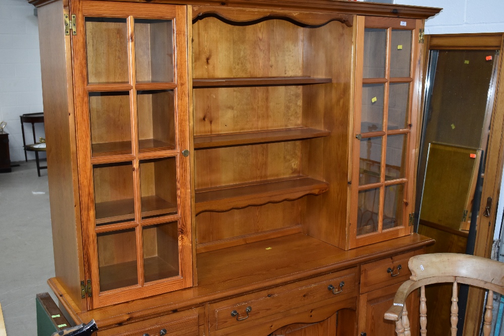 A modern pine dresser having part glazed upper section, width approx. 172cm