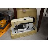 A vintage Pfaff 294 electric sewing machine with moulded plastic case