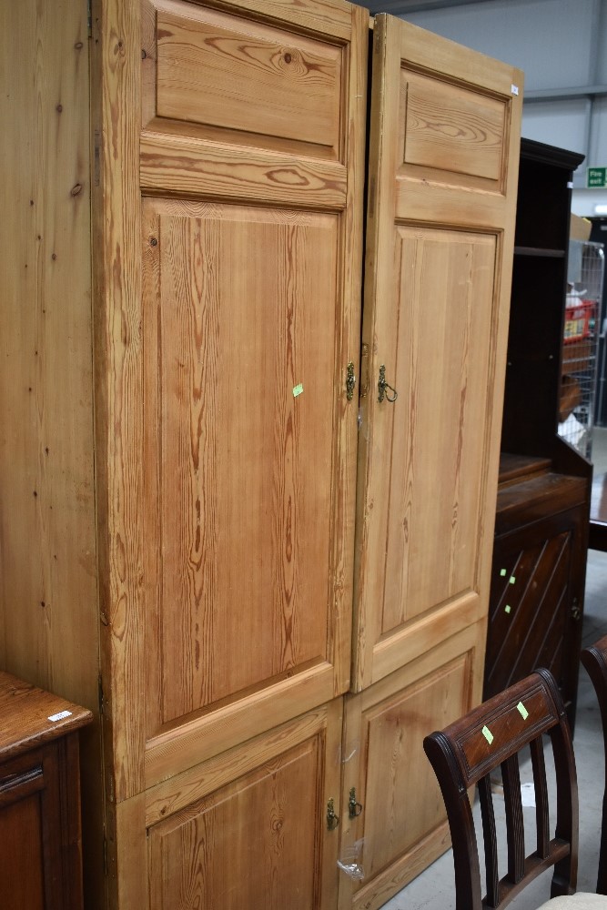 An Antique pine panelled double cupboard/robe with cupboard base, dimensions approx. W127cm D40cm