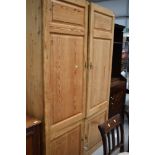 An Antique pine panelled double cupboard/robe with cupboard base, dimensions approx. W127cm D40cm