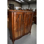 An early 20th Century stained frame display cabinet having serpentine front, width approx. 105cm