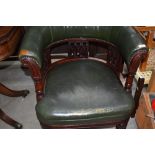 A Victorian mahogany and green leather tub chair