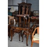 A mid 20th Century dining table and four chairs, on cabriole legs, approx. 136 x 93cm