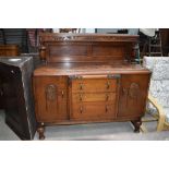 A mid 20th Century oak sideboard having ledge back ( loose leg)