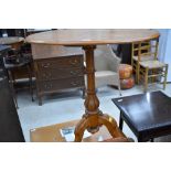 A Victorian satinwood occasional table having oval top on turned column and triple splay base, width