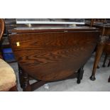 A modern drop leaf dining table with a dark oak stain