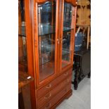 A modern cherry style display cabinet having three drawer base, width approx. 84cm