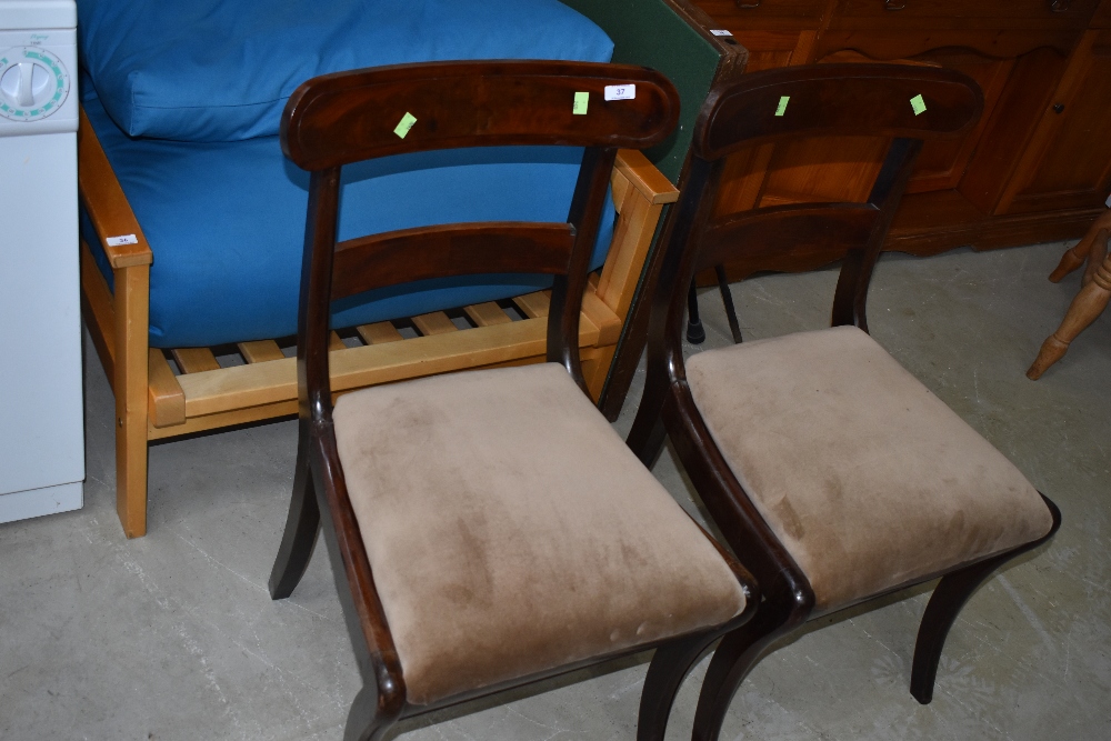 A pair of Regency style mahogany dining chairs