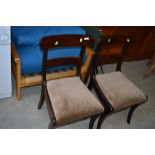 A pair of Regency style mahogany dining chairs