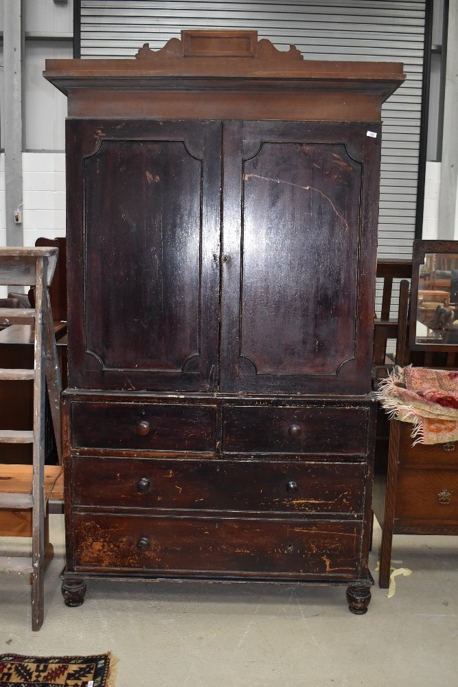 A 19th Century stained frame linen press, on drawer base (two over one deep - false front)