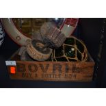 A vintage wooden Bovril box,a glass float and an assortment of cork fishing net floats.