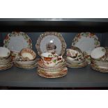 A collection of cups and saucers,plates,bowl and jug having brown, green and navy pattern with