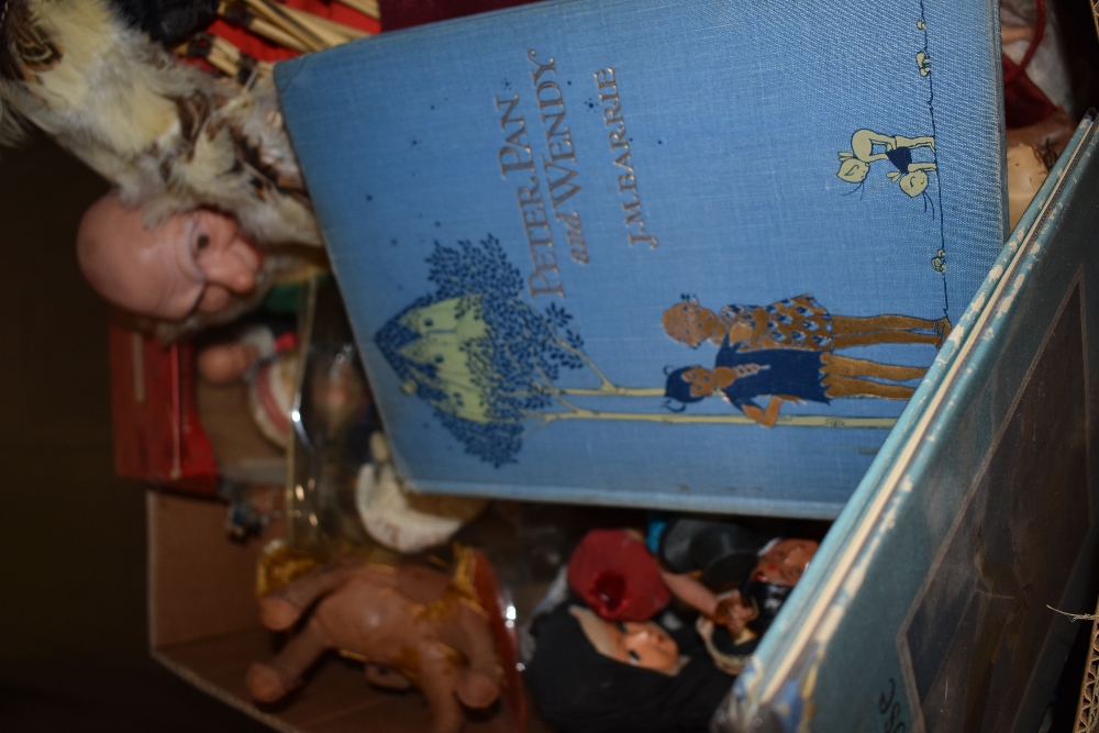 A selection of unusual world interest dolls and Peter Pan book illustrated by Mabel Lucie Attwell