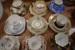 A collection of cups and saucers, some with side plates, includes Royal Stewart with fluted edges,