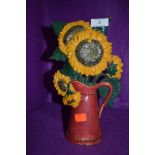 A cast door stop with design of sunflowers in jug.