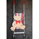 A vintage childrens Play buggy and teddy bear