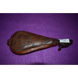 A Victorian leather shot dispenser having hunting scene with gun dog and bird embossed detail.